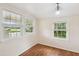 This bedroom features ample natural light with wooden floors and an elegant chandelier at 106 N Pine St, Summerville, SC 29483