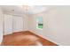 Bedroom with hardwood floors, a window, and white trim and baseboards at 106 N Pine St, Summerville, SC 29483