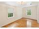 Light filled bedroom with hardwood floors and two bright, window views at 106 N Pine St, Summerville, SC 29483