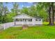 Charming single-story home boasts a well-manicured lawn, brick pathway, and a welcoming front porch at 106 N Pine St, Summerville, SC 29483