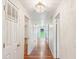 Long hallway features hardwood floors, decorative light fixture, and views to outside at 106 N Pine St, Summerville, SC 29483