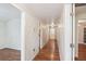 Bright hallway showcases hardwood floors, neutral walls, and leads to multiple rooms at 106 N Pine St, Summerville, SC 29483
