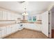 Well-lit kitchen offers ample counter space, white cabinetry, and open access to other rooms at 106 N Pine St, Summerville, SC 29483