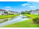 Peaceful backyard featuring a pond with a fountain and well-maintained landscaping at 108 Hemingway Cir, Summerville, SC 29483