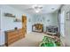 Cozy bedroom featuring neutral carpet, a ceiling fan, a wooden dresser, and a crib with stuffed animals at 108 Hemingway Cir, Summerville, SC 29483