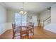 Cozy dining area with hardwood floors, a chandelier, and easy access to the staircase at 108 Hemingway Cir, Summerville, SC 29483