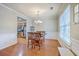 Elegant dining room featuring hardwood floors, wainscoting, a chandelier, and natural light at 108 Hemingway Cir, Summerville, SC 29483