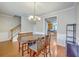 Inviting dining room with hardwood floors, a stylish chandelier, and an adjacent staircase at 108 Hemingway Cir, Summerville, SC 29483