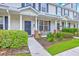 Charming townhome featuring well-manicured landscaping, a cozy front porch, and stylish architectural details at 108 Hemingway Cir, Summerville, SC 29483