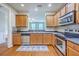 Modern kitchen featuring stainless steel appliances, wooden cabinets, and a view into the living room at 108 Hemingway Cir, Summerville, SC 29483
