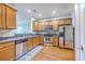 Well-lit kitchen features wood cabinets, stainless steel appliances and hard wood floors at 108 Hemingway Cir, Summerville, SC 29483
