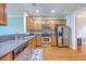 Well-lit kitchen features wood cabinets, stainless steel appliances and hard wood floors at 108 Hemingway Cir, Summerville, SC 29483