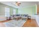 Bright living room with a plush sectional couch, wood floors, and natural lighting at 108 Hemingway Cir, Summerville, SC 29483
