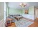 Bright living room with a plush sectional couch, wood floors, and natural lighting at 108 Hemingway Cir, Summerville, SC 29483