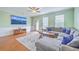 Bright living room with a plush sectional couch, wood floors, and natural lighting at 108 Hemingway Cir, Summerville, SC 29483