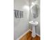 Bright powder room features pedestal sink, hard wood floors and modern fixtures at 108 Hemingway Cir, Summerville, SC 29483