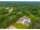 An aerial view displays two charming single-story homes nestled in the midst of a lush green forest neighborhood at 108 Swanson Dr, Summerville, SC 29483