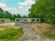 Aerial shot of a manufactured home featuring a front deck and a long gravel driveway at 108 Swanson Dr, Summerville, SC 29483