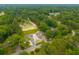An aerial view showcasing two homes surrounded by a beautiful and expansive green forest at 108 Swanson Dr, Summerville, SC 29483