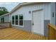 A welcoming side entrance via the wooden deck on a gray and white home at 108 Swanson Dr, Summerville, SC 29483