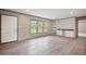 Bright living room features three windows and built-in shelves. with hardwood style flooring at 108 Swanson Dr, Summerville, SC 29483