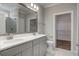 Bathroom featuring double vanity sinks, large mirror, and walk-in closet providing both style and functionality at 116 Crosscut Ln, Summerville, SC 29486