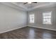 Spacious bedroom with hardwood floors, two windows, and a ceiling fan at 116 Crosscut Ln, Summerville, SC 29486