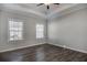 Bright bedroom with hardwood floors, two windows, and a tray ceiling with fan at 116 Crosscut Ln, Summerville, SC 29486
