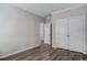 Neutral bedroom features LVP flooring, white trim, and closet with double doors at 116 Crosscut Ln, Summerville, SC 29486
