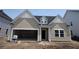 New construction exterior featuring a two-car garage and neutral siding at 116 Crosscut Ln, Summerville, SC 29486