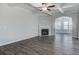 Living room with a fireplace and hardwood floors, flowing into another room through an arched doorway at 116 Crosscut Ln, Summerville, SC 29486