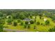 Expansive aerial view of a home with a long driveway, lush greenery, and outbuildings at 117 Ponderosa Rd, Summerville, SC 29483