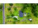 Aerial view of the property highlighting the home, pool, deck, landscaping, and surrounding greenery at 117 Ponderosa Rd, Summerville, SC 29483