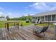 Spacious backyard deck with outdoor seating, dining table and hot tub overlooking the expansive green lawn at 117 Ponderosa Rd, Summerville, SC 29483