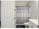 Bathroom with a toilet, shower with a striped curtain, and a door to the side at 117 Ponderosa Rd, Summerville, SC 29483