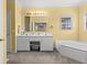 Bathroom featuring double sinks, tub, and window providing natural light at 117 Ponderosa Rd, Summerville, SC 29483