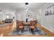 Well-lit dining room with a decorative wagon wheel, hard wood floors, and a view of the living room at 117 Ponderosa Rd, Summerville, SC 29483