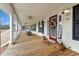 Inviting front porch with rocking chairs and a decorative door at 117 Ponderosa Rd, Summerville, SC 29483