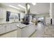 Well-lit kitchen featuring an island cooktop, modern appliances, and an adjacent dining area at 117 Ponderosa Rd, Summerville, SC 29483