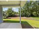 View of the backyard with a patio, green grass, and lush trees, creating a peaceful outdoor retreat at 125 Ridge Rd, Summerville, SC 29485