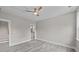 Bedroom with ceiling fan, gray laminate floors and views into the ensuite bath at 125 Ridge Rd, Summerville, SC 29485