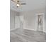 Bedroom with views to bathroom, gray floors, and a ceiling fan at 125 Ridge Rd, Summerville, SC 29485