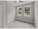 Cozy bedroom with gray vinyl flooring, two windows, and a closet at 125 Ridge Rd, Summerville, SC 29485