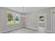 Dining area with a chandelier, large window, and neutral color palette at 125 Ridge Rd, Summerville, SC 29485