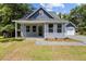 Charming bungalow with blue siding, a covered front porch, and a detached garage at 125 Ridge Rd, Summerville, SC 29485