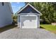 Detached garage with gravel driveway and blue and white exterior at 125 Ridge Rd, Summerville, SC 29485