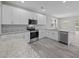 Bright kitchen with white cabinetry, granite countertops, stainless appliances and gray tile backsplash at 125 Ridge Rd, Summerville, SC 29485