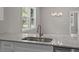 Kitchen granite island sink with stainless faucet, white cabinetry and lots of natural light at 125 Ridge Rd, Summerville, SC 29485