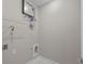 Laundry room featuring wall-mounted tankless hot water heater and white marble floors at 125 Ridge Rd, Summerville, SC 29485
