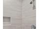 Bathroom shower showcasing white, stone look tile, a built-in niche, and chrome fixtures at 125 Ridge Rd, Summerville, SC 29485